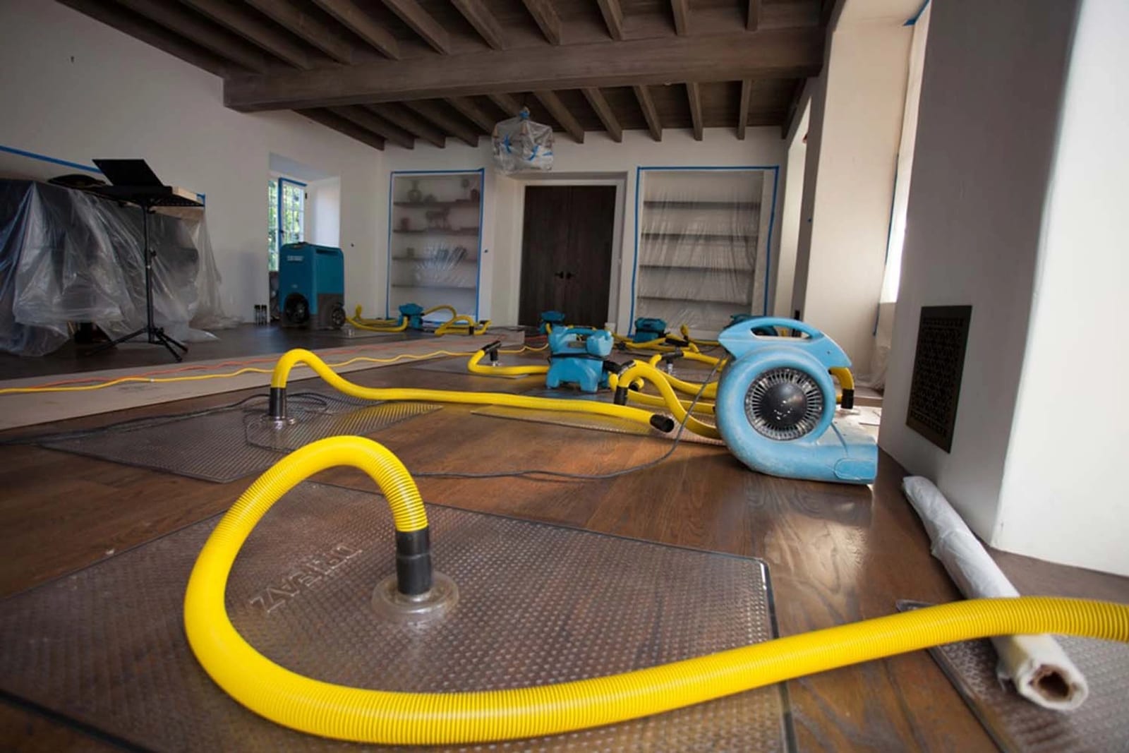 Air movers and drying hoses deployed for structural drying after flooding